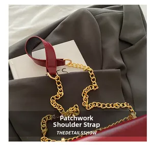 Detail of burgundy shoulder bag with gold chain strap and premium faux leather finish