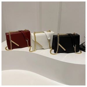 Three elegant small crossbody bags in burgundy white and black with gold chain straps