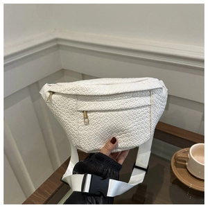 Detailed view of white woven texture on crossbody bum bag with golden zippers