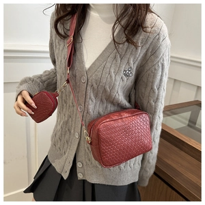 Detail of red woven leather camera bag with wide strap and matching round coin purse