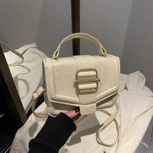 Détail du sac à main crème en cuir PU avec boucle dorée et poignée supérieure