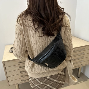 Chic black woven crossbody chest bag for women with adjustable strap and metallic zipper