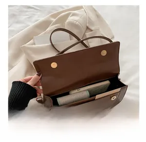 Interior view showing the large capacity of a vintage brown leather baguette bag