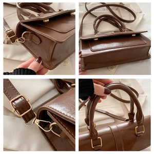 Detail view of dark brown PU leather bag showing glossy texture and gold metal hardware