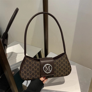 Vintage brown monogram hobo bag with gold M buckle and elegant crescent shape