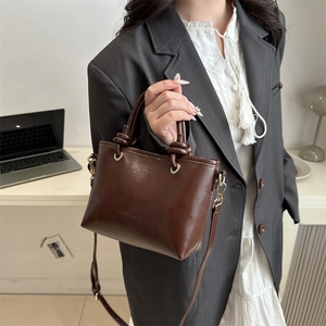 Sac bandoulière marron foncé rétro avec poignée torsadée et logo embossé
