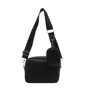 Minimalist black woven crossbody bag with round coin purse and gold hardware on white background
