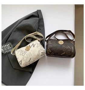 Close-up of retro cylinder crossbody bags with vintage gold logo and letter print straps