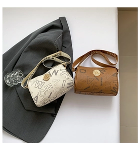 Detail of trendy cylinder crossbody bags in beige and brown with letter print and wide strap