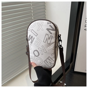 Detailed close-up of white pebble leather crossbody bag with bold graphic lettering