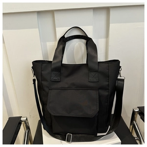Close-up of waterproof nylon tote bag featuring adjustable strap and silver metal hardware