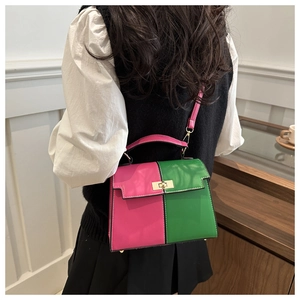 Detail of pink and green contrast crossbody bag with gold lock worn by model