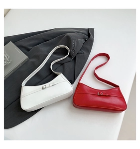 Detail of minimalist half-moon underarm bags in classic white and burgundy matte leather
