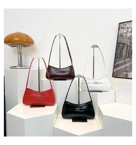 Chic retro underarm bags in red, brown, white and black colors displayed on white pedestals