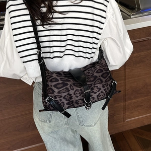 Sac bandoulière imprimé léopard avec garniture en cuir noir et boucles métalliques