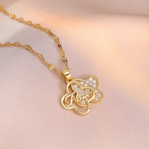 Double-layered golden four-leaf flower necklace with zircon petals and flower engraving
