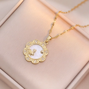 Close-up of rabbit shell necklace with sparkling cubic zirconia on beige silk background