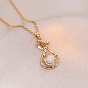 Golden necklace with fortune bag pendant featuring sparkling zircons and opal stone detail