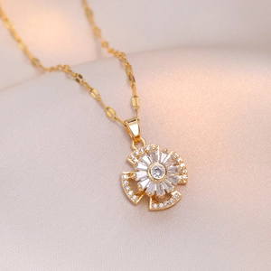 Rotating zircon flower pendant on a gold titanium steel necklace for women