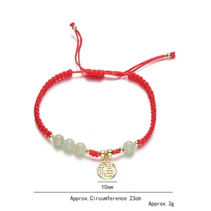 Handwoven red rope bracelet with strawberry crystal beads and golden Fu character pendant