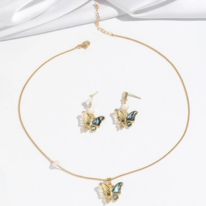 Detail of butterfly necklace and earrings set with mother-of-pearl and freshwater pearls
