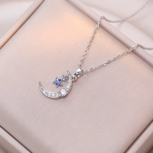 Blue star and moon silver necklace with sparkling zircon pendant on satin jewelry box