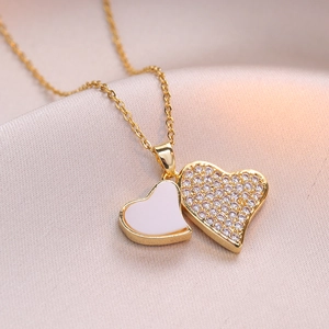 Elegant gold double heart necklace with crystal paving and white enamel pendant