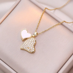Golden double heart pendant necklace with pink enamel and sparkling white zircons