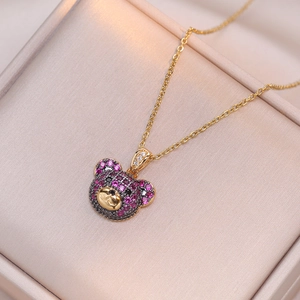 Chic gold-plated necklace featuring a teddy bear pendant with purple and black crystals