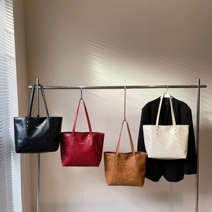 Minimalist large leather tote bags in black, burgundy, brown, and cream for daily commute