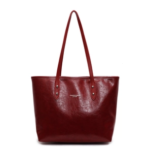 Classic deep red leather tote bag with grainy texture and silver rivet hardware