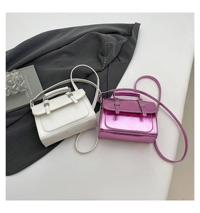 Detail of compact square handbags in white and metallic purple with crinkled texture