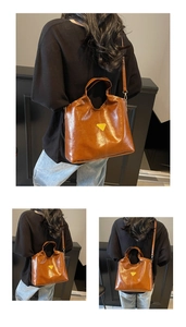 Close-up of brown patent leather tote bag with iconic triangle logo and slim shoulder strap