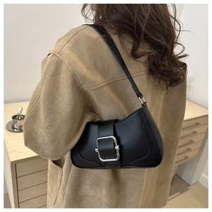 Chic black matte underarm bag with silver square buckle shown on model's shoulder