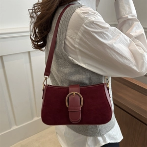 Retro burgundy frosted suede underarm bag with gold horseshoe buckle on model
