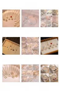 Detailed collection of 18K gold clover necklaces, pearl bracelets, and heart pendants