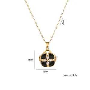 Gold spinning clover necklace with black enamel petals and cubic zirconia accents