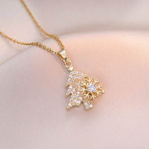Golden titanium steel Christmas tree necklace with spinning snowflake and pavé crystals