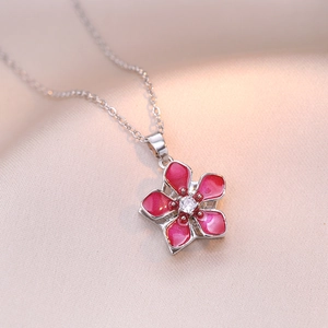 Rotating cherry blossom necklace with pink petals and zircon center on champagne silk