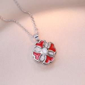 Elegant rotating red enamel flower pendant necklace with white zircon in silver finish