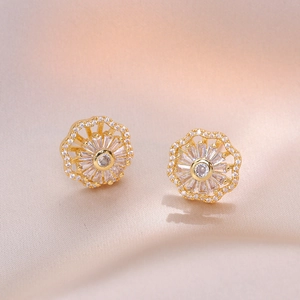 Golden flower zircon necklace and earrings set on champagne satin background