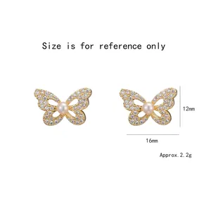 Elegant gold bow earrings with freshwater pearl and cubic zirconia stones in white background
