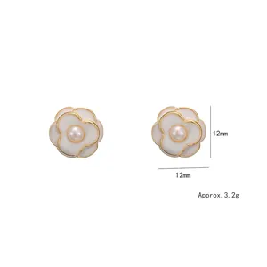 White enamel camellia pearl stud earrings with gold trim and 12mm floral design