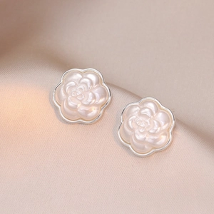 Elegant pearl white camellia flower stud earrings with silver edges on silk fabric