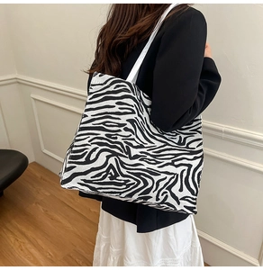 Large zebra print canvas tote bag shown on model for size and style reference