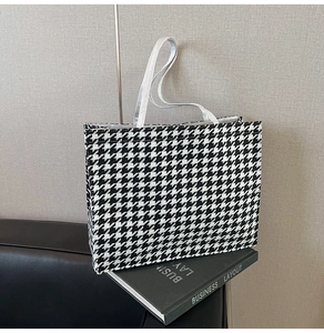 Macro detail of houndstooth wool tote bag texture and high-quality woven handles