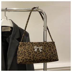 Detail of leopard print suede shoulder bag with silver bow buckle on metal hanger