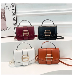 Detail of four colorful vintage flap crossbody bags with golden buckle on white podiums