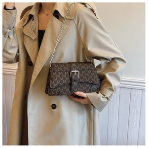 Detail of vintage M-letter print crossbody bag with silver chain strap and pin buckle