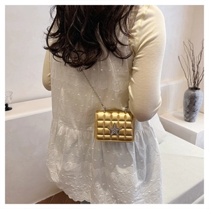 Detailed back view of a gold crossbody bag with star rhinestone and chain strap